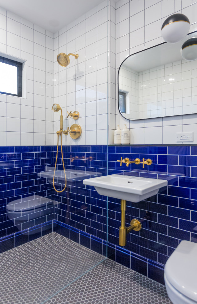 Photo of a small kids bathroom in Vancouver with an alcove shower, a wall-mount toilet, blue tile, ceramic tile, white walls, mosaic tile floors, a wall-mount sink and grey floor.
