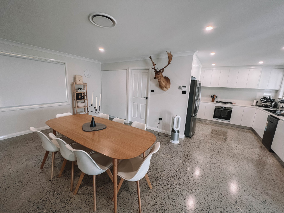 This is an example of a medium sized scandinavian open plan dining room in Newcastle - Maitland with white walls, concrete flooring, grey floors, a timber clad ceiling and wood walls.