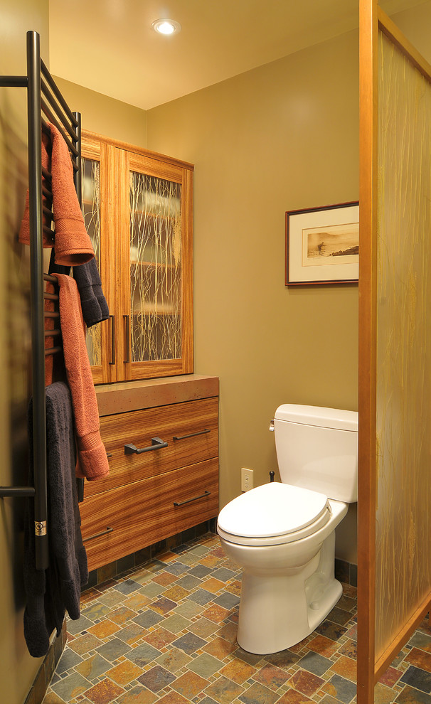 Mid-sized mountain style master multicolored tile and stone tile slate floor doorless shower photo in Seattle with a vessel sink, flat-panel cabinets, medium tone wood cabinets, concrete countertops, a two-piece toilet and green walls