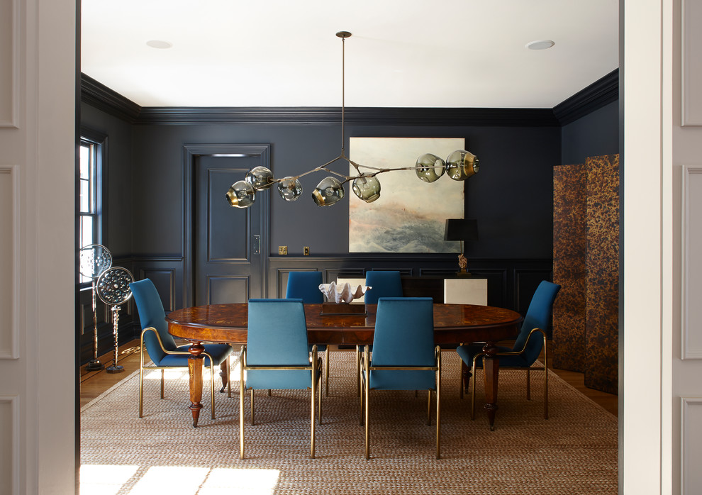 Contemporary separate dining room in New York with black walls, medium hardwood floors and brown floor.