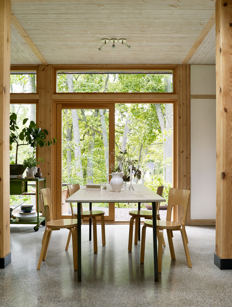 Asian dining room in Stockholm with white walls, concrete floors and grey floor.