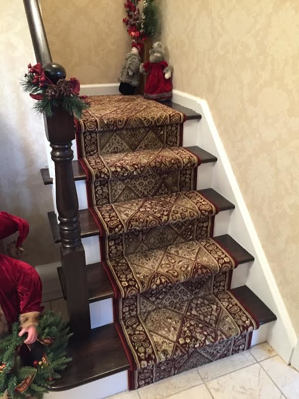 Example of a small carpeted l-shaped staircase design in New York with wooden risers
