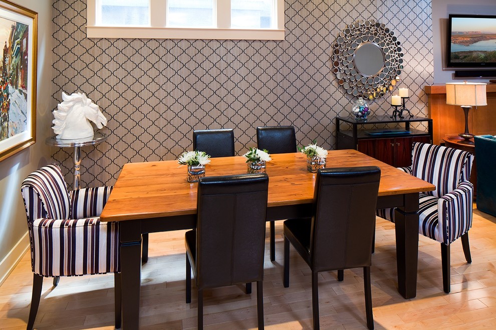 Photo of a contemporary dining room in Other with multi-coloured walls and medium hardwood floors.