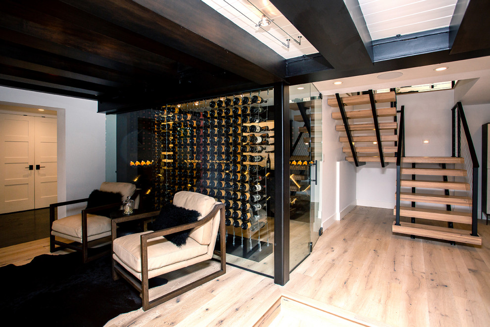 Inspiration for a mid-sized modern wine cellar in Portland with medium hardwood floors, storage racks and brown floor.