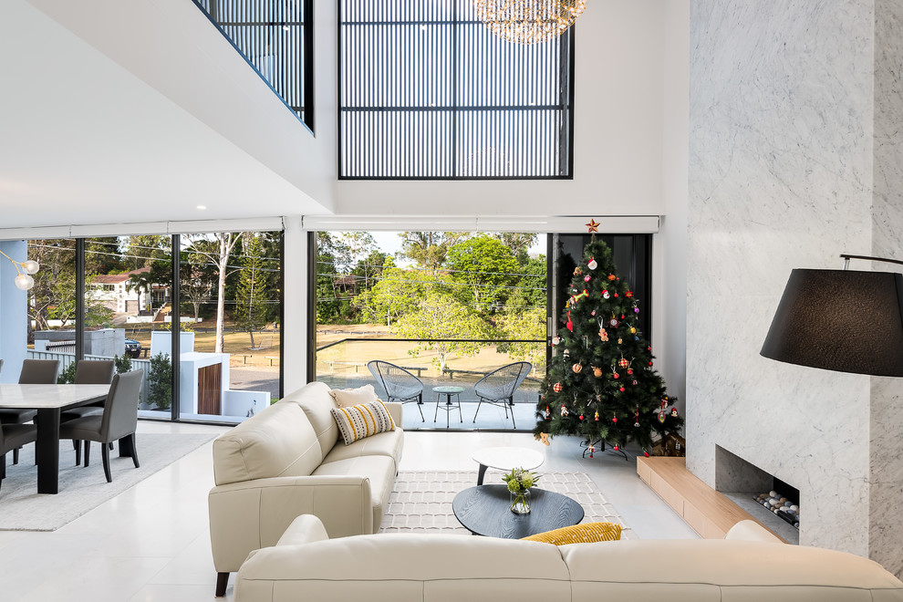 Photo of a mid-sized modern open concept living room in Brisbane with white walls, marble floors, a ribbon fireplace, a stone fireplace surround, no tv and white floor.
