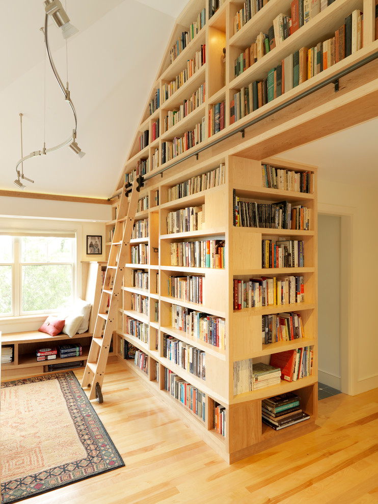 Photo of a large contemporary home office in Burlington with white walls, medium hardwood floors and a library.