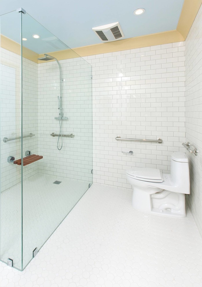 Inspiration for a mid-sized traditional bathroom in San Francisco with an undermount sink, flat-panel cabinets, beige cabinets, marble benchtops, a corner tub, a curbless shower, a one-piece toilet, white tile, ceramic tile, white walls and ceramic floors.