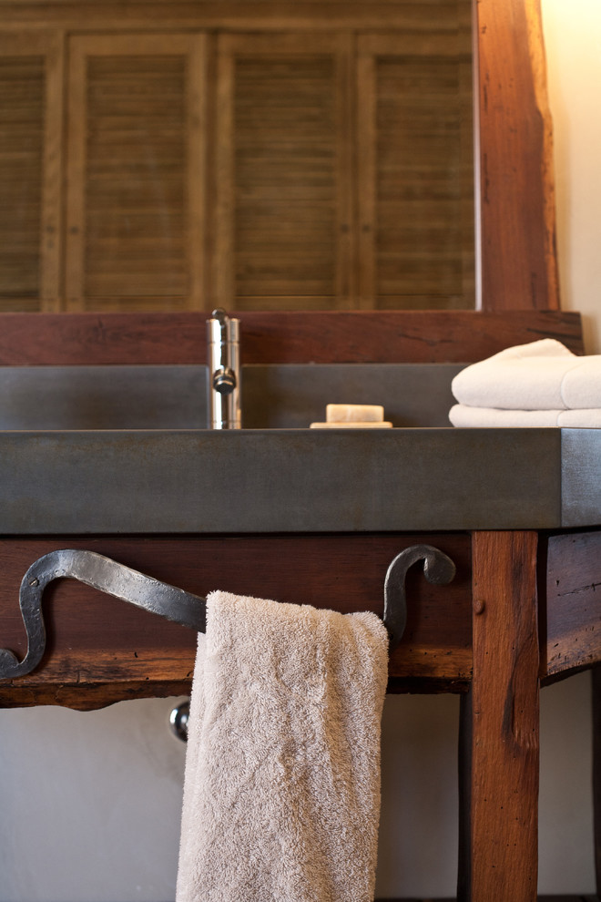Example of a mountain style home design design with a trough sink, furniture-like cabinets and concrete countertops