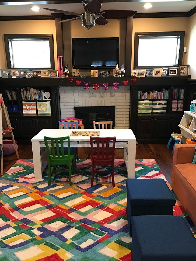 This is an example of a mid-sized transitional kids' room for girls in Tampa with beige walls and dark hardwood floors.