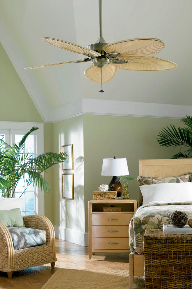 Inspiration for a mid-sized tropical master bedroom in San Diego with green walls, medium hardwood floors and no fireplace.
