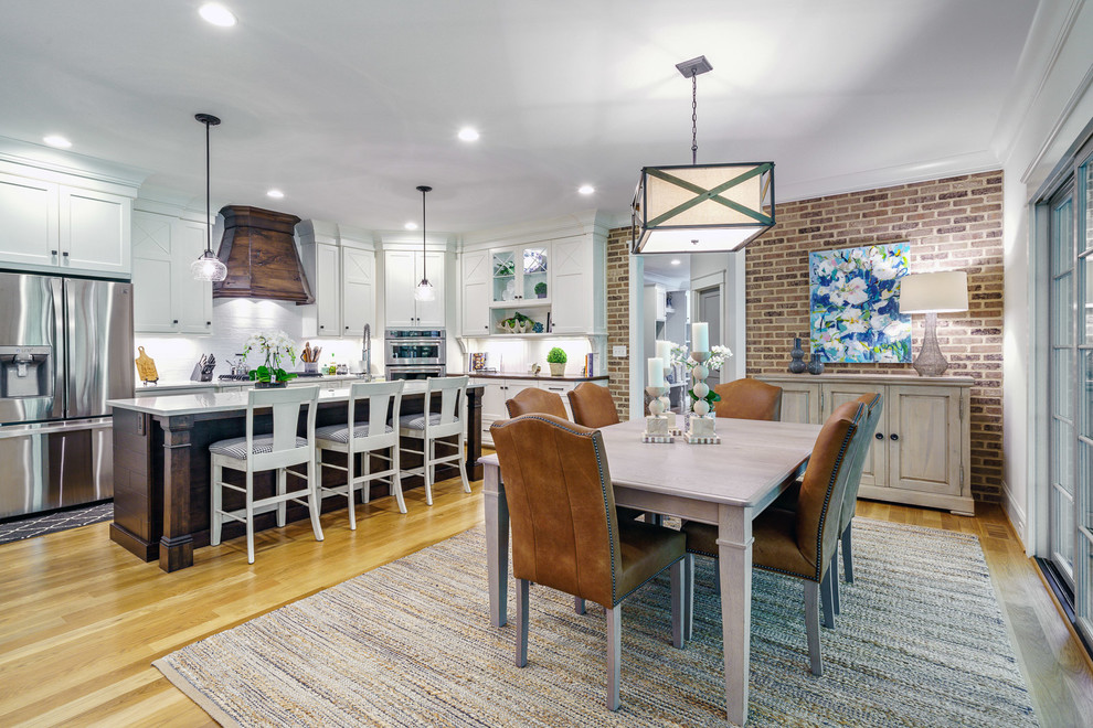Large transitional u-shaped medium tone wood floor and brown floor eat-in kitchen photo with a farmhouse sink, recessed-panel cabinets, white cabinets, quartz countertops, white backsplash, ceramic backsplash, stainless steel appliances, an island and white countertops