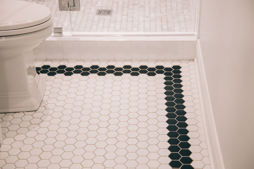 Inspiration for a mid-sized contemporary 3/4 bathroom in Birmingham with an alcove shower, black and white tile, porcelain tile, porcelain floors, recessed-panel cabinets, white cabinets, a one-piece toilet, white walls, an undermount sink and marble benchtops.