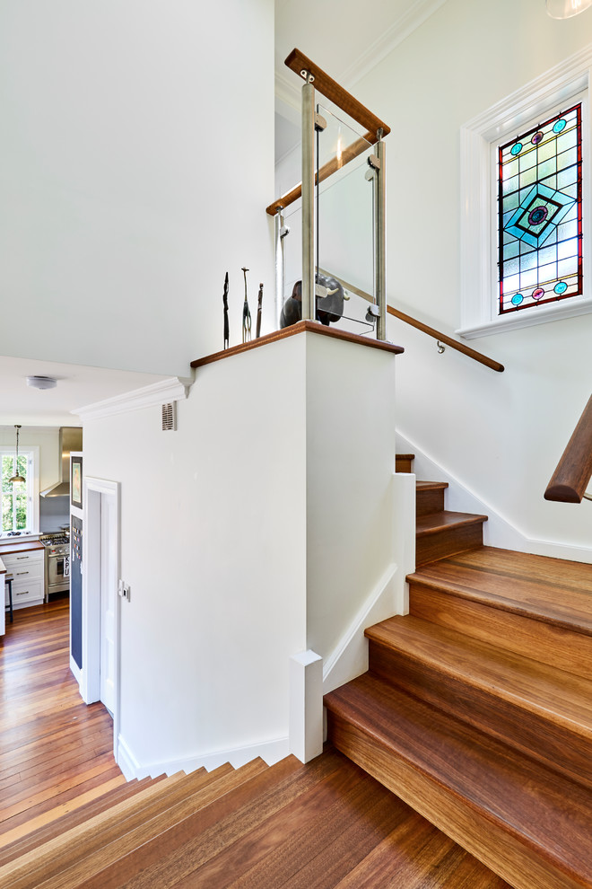 Eclectic wood u-shaped staircase in Sydney with wood risers and wood railing.