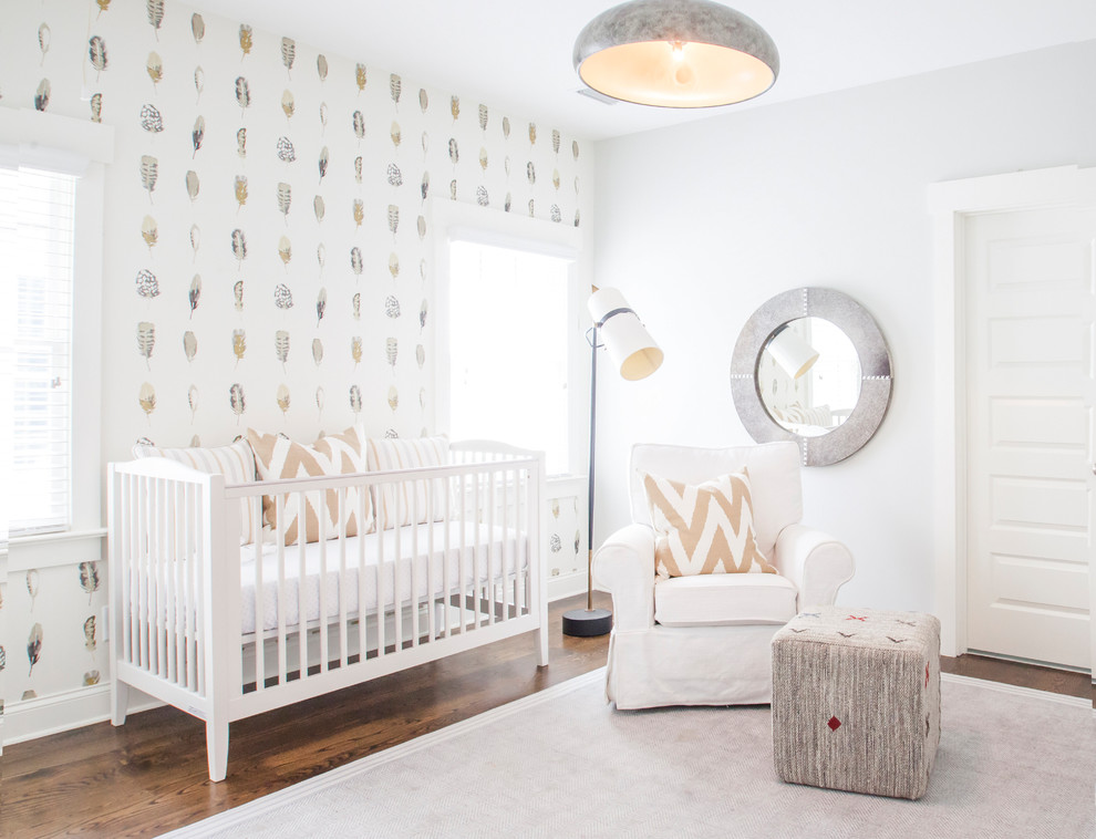 This is an example of a transitional gender-neutral nursery in Charlotte with multi-coloured walls, dark hardwood floors and brown floor.