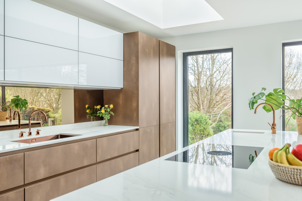 This is an example of a contemporary single-wall eat-in kitchen in Sussex with with island.