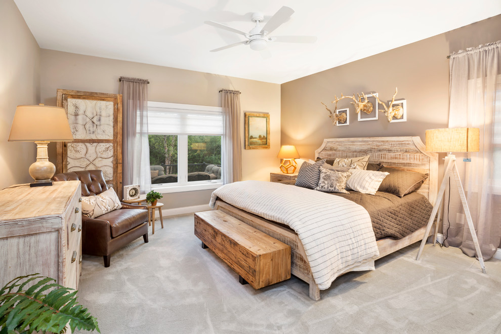 This is an example of a mid-sized country guest bedroom in Cincinnati with beige walls, carpet and grey floor.