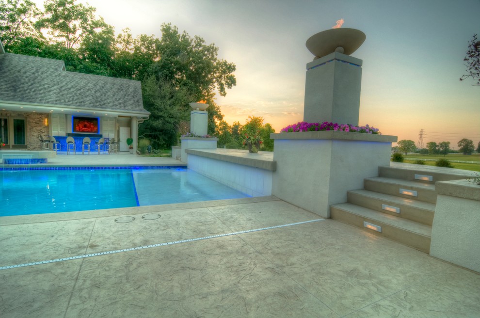 Inspiration for a large transitional backyard concrete paver and rectangular natural hot tub remodel in Cedar Rapids