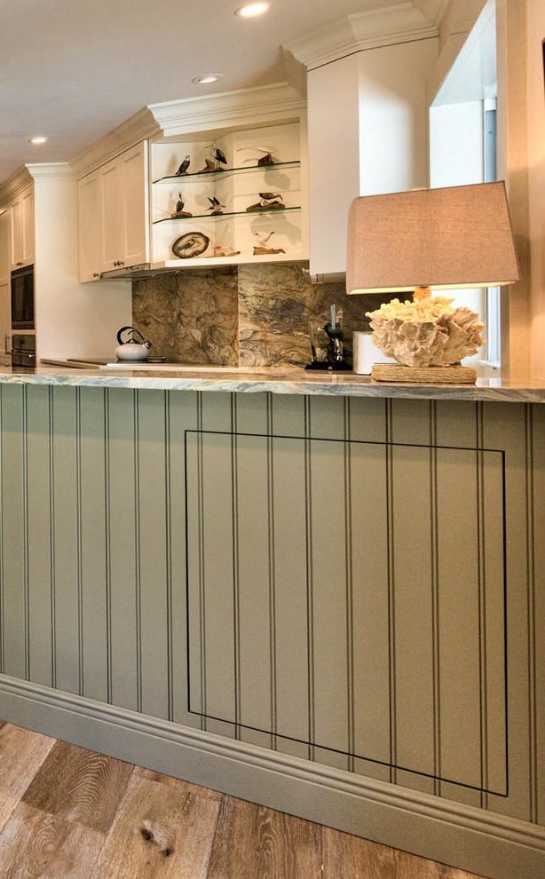 Inspiration for a mid-sized transitional u-shaped medium tone wood floor open concept kitchen remodel in Miami with an undermount sink, shaker cabinets, white cabinets, granite countertops, multicolored backsplash, stone slab backsplash, stainless steel appliances and an island