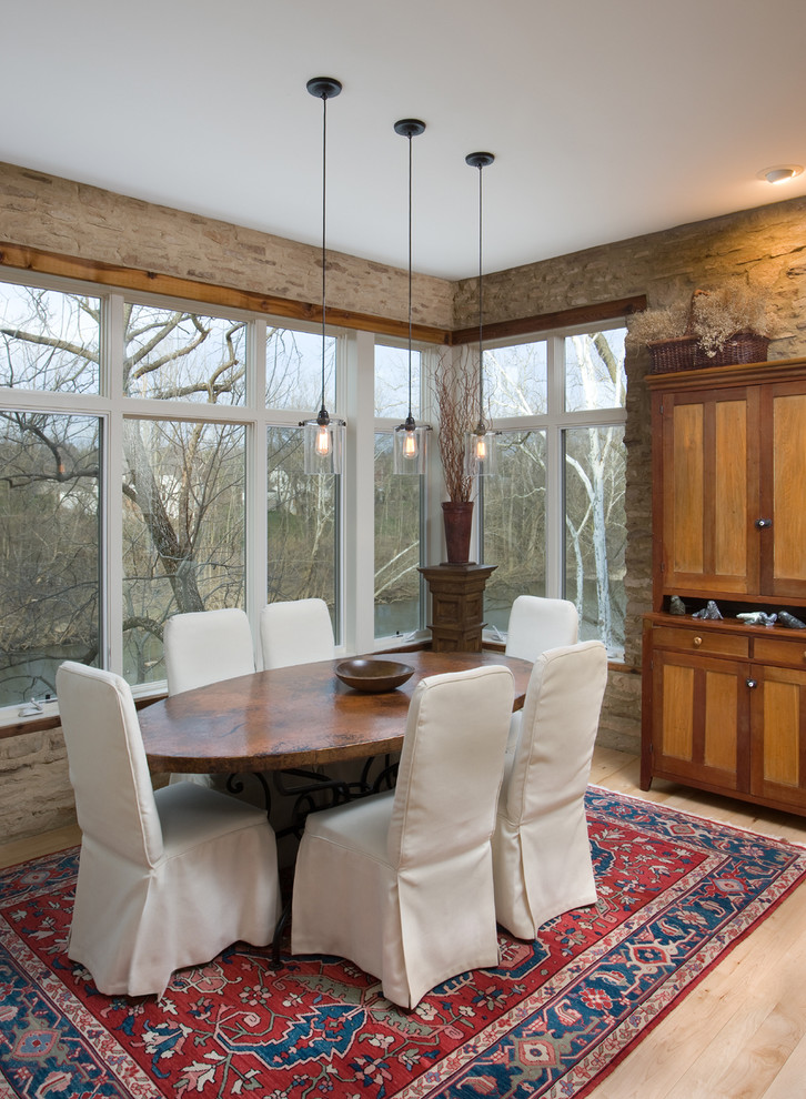 Inspiration for a country dining room in Columbus with light hardwood floors.
