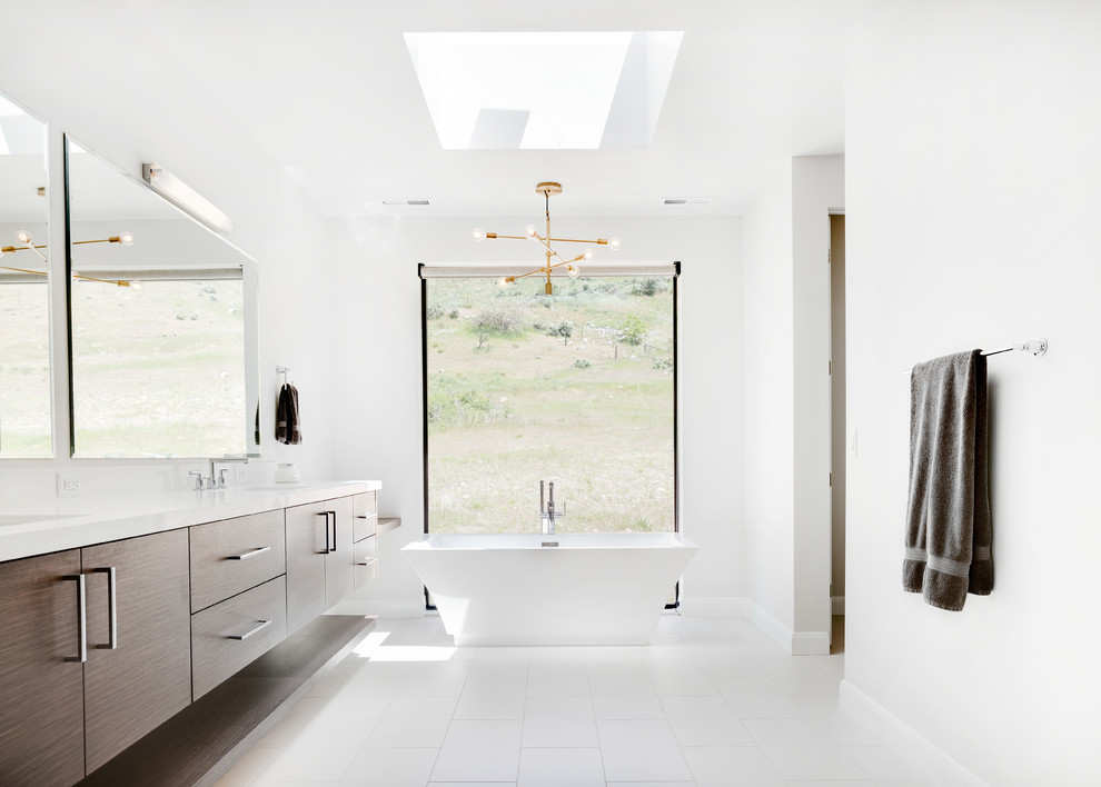 Design ideas for a contemporary master bathroom in Salt Lake City with flat-panel cabinets, dark wood cabinets, a freestanding tub, white walls and white floor.