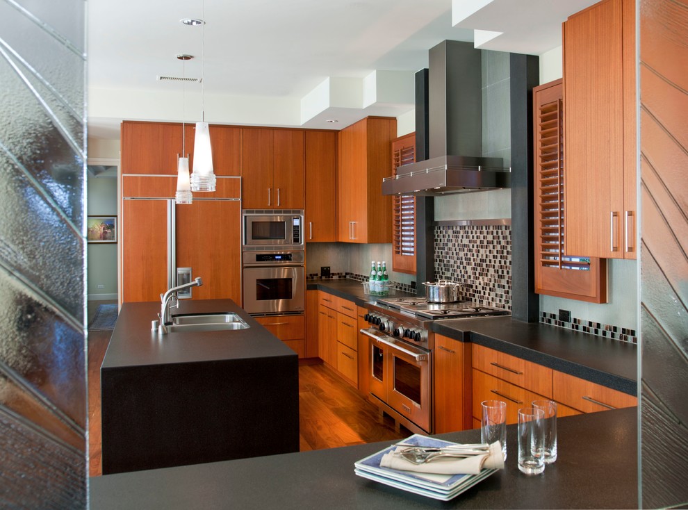 Design ideas for a mid-sized contemporary u-shaped eat-in kitchen in San Diego with a double-bowl sink, flat-panel cabinets, dark wood cabinets, multi-coloured splashback, mosaic tile splashback, stainless steel appliances, dark hardwood floors and with island.