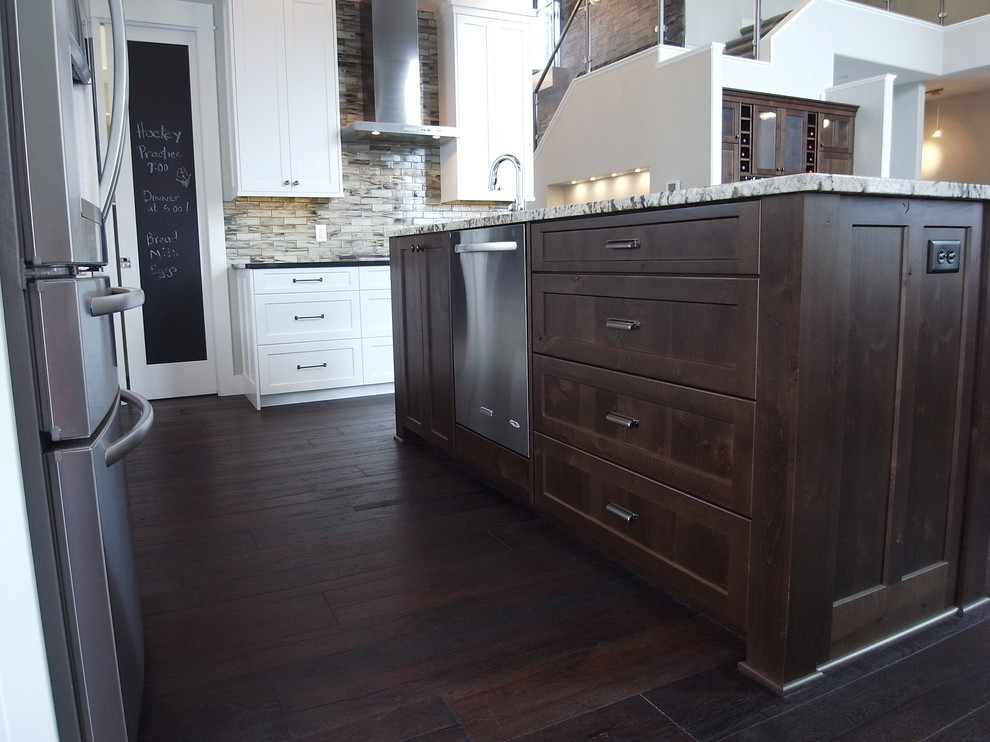 Transitional open concept kitchen photo with white cabinets, stainless steel appliances, an island and flat-panel cabinets