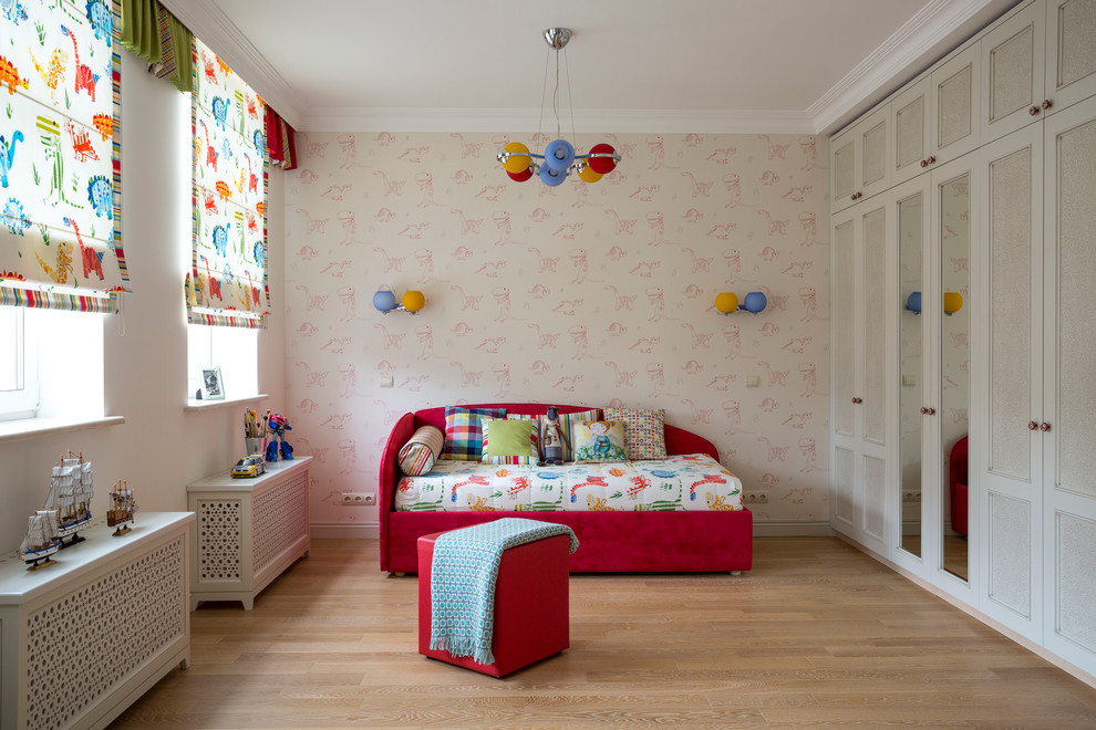 This is an example of a mid-sized contemporary gender-neutral kids' bedroom in Moscow with multi-coloured walls and light hardwood floors.