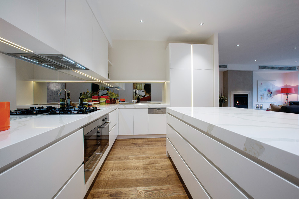 Inspiration for a mid-sized contemporary l-shaped open plan kitchen in Melbourne with marble benchtops, with island, a double-bowl sink, flat-panel cabinets, white cabinets, mirror splashback, stainless steel appliances and dark hardwood floors.