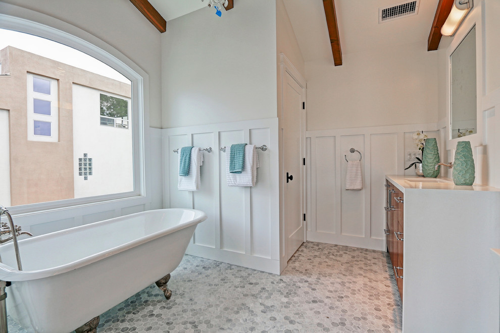 Mid-sized beach style master bathroom in Los Angeles with flat-panel cabinets, medium wood cabinets, a claw-foot tub, a corner shower, gray tile, white walls, marble floors, an undermount sink and engineered quartz benchtops.