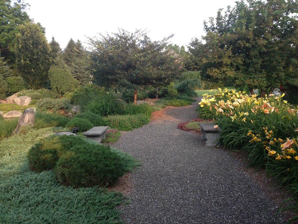 Mid-sized traditional backyard formal garden in Boston with a water feature and gravel.