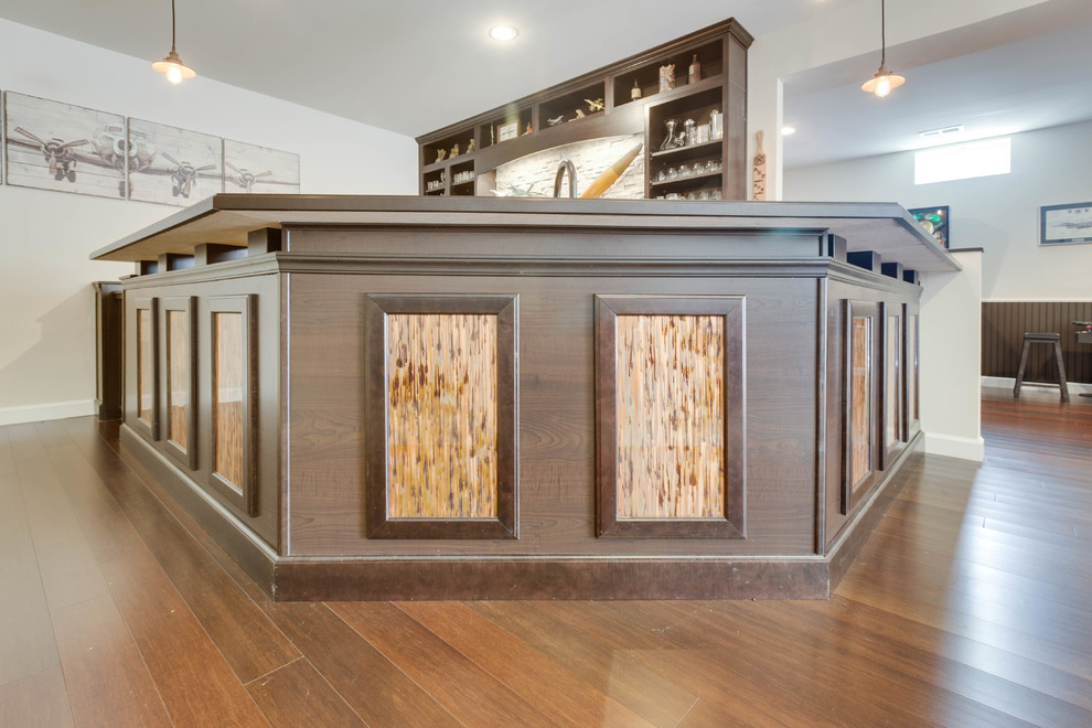 Design ideas for a large modern u-shaped wet bar in DC Metro with a drop-in sink, recessed-panel cabinets, copper benchtops, stone tile splashback and medium hardwood floors.