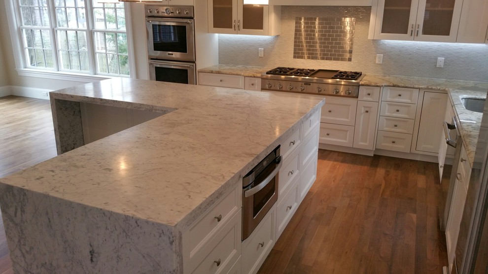 This is an example of a traditional kitchen in Boston with grey splashback and stainless steel appliances.