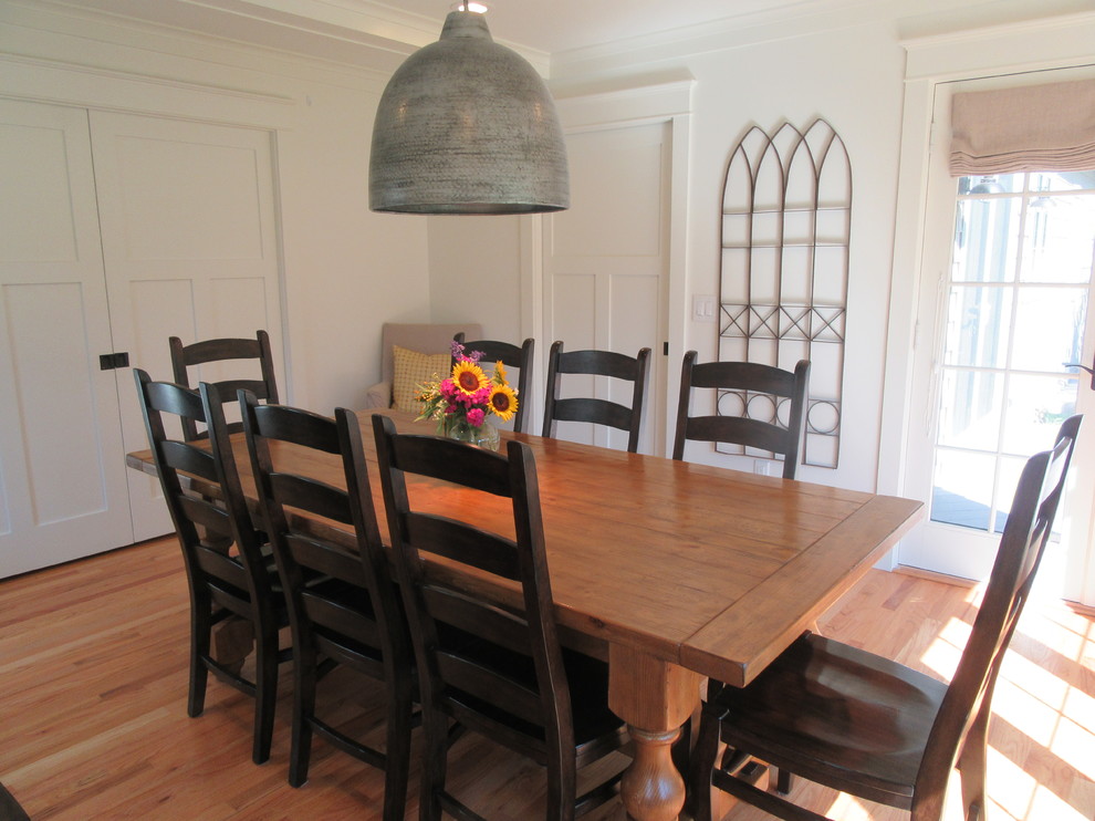 Photo of a mid-sized country separate dining room in Detroit with beige walls, medium hardwood floors and no fireplace.