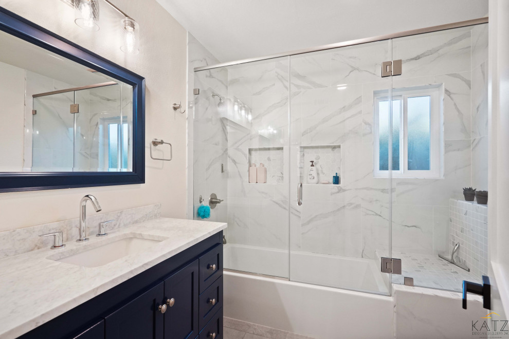 Идея дизайна: ванная комната с синими фасадами, унитазом-моноблоком, белой плиткой, мраморной плиткой, бежевыми стенами, паркетным полом среднего тона, консольной раковиной, мраморной столешницей, оранжевым полом, белой столешницей, тумбой под одну раковину и встроенной тумбой