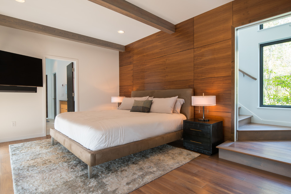 Photo of a contemporary master bedroom in Minneapolis with brown walls, medium hardwood floors and brown floor.