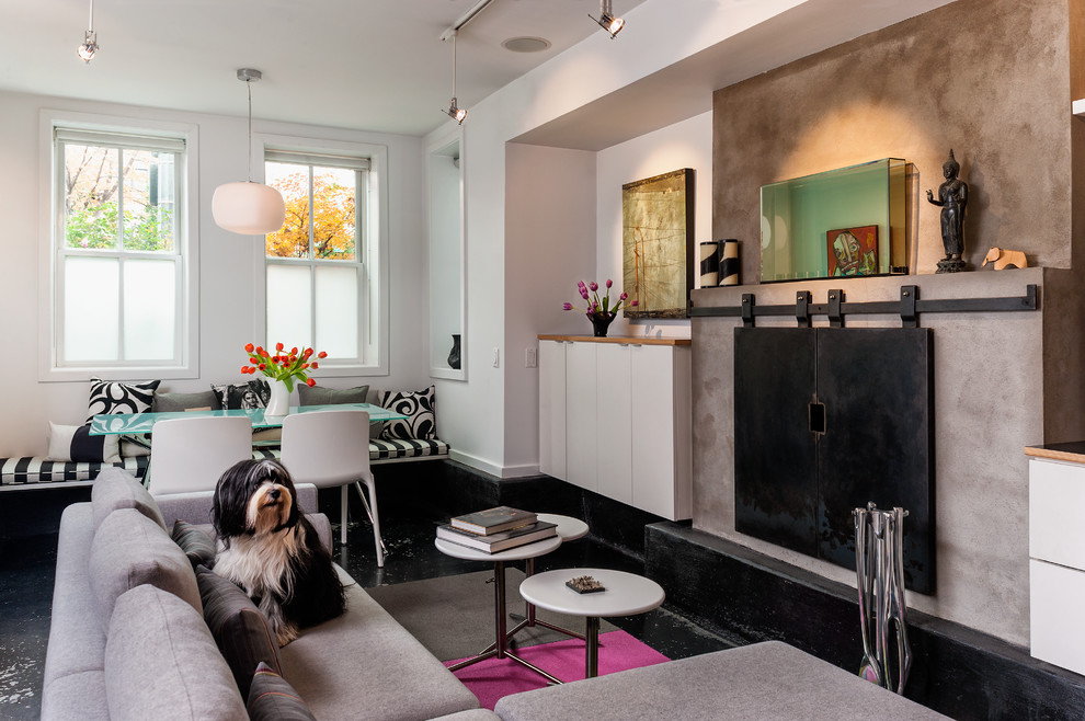 Photo of a contemporary open concept living room in DC Metro with white walls and concrete floors.