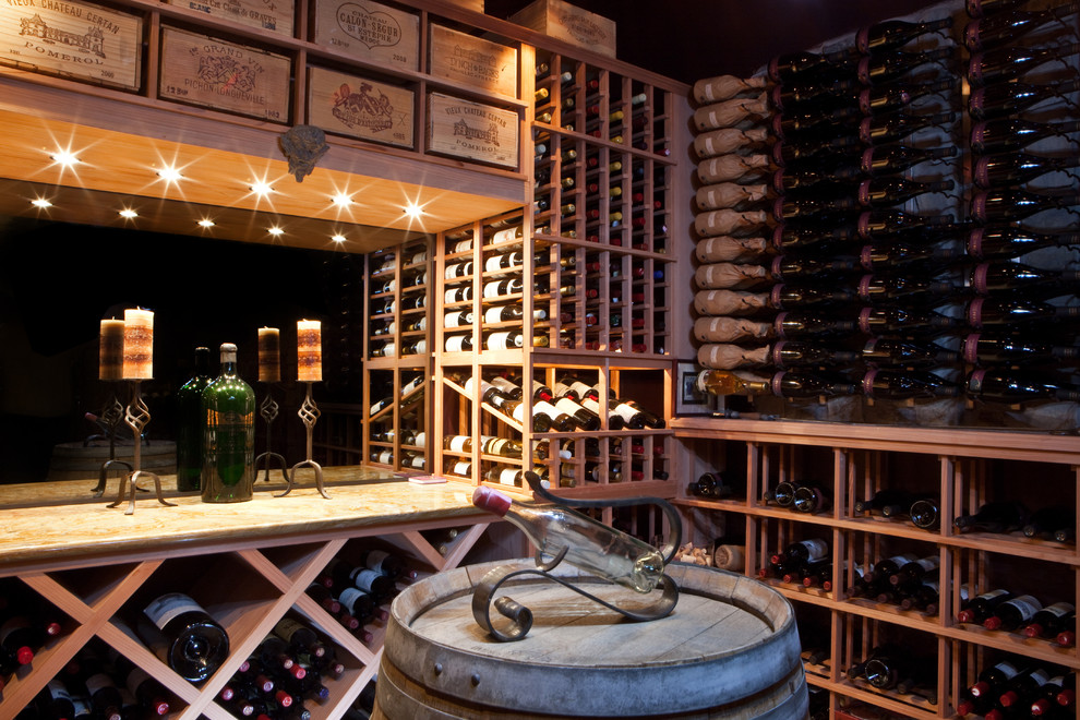 This is an example of a mid-sized traditional wine cellar in Phoenix with storage racks, porcelain floors and beige floor.