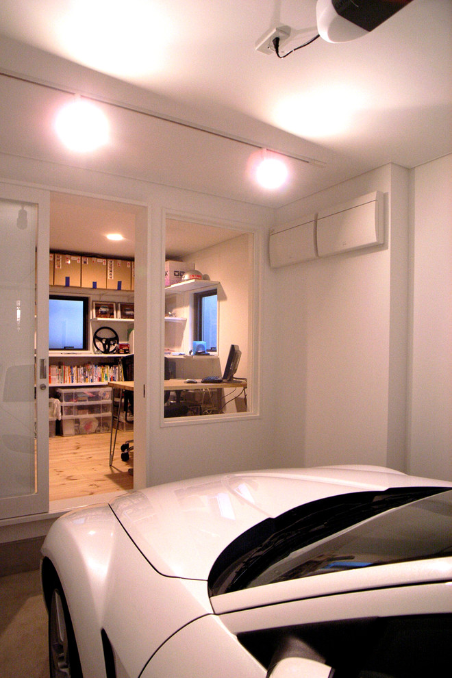 Example of a small minimalist one-car carport design in Other