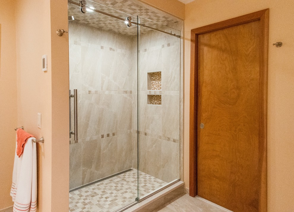 Mid-sized transitional master beige tile and porcelain tile porcelain tile double shower photo with flat-panel cabinets, medium tone wood cabinets, a one-piece toilet, beige walls, an undermount sink and quartz countertops
