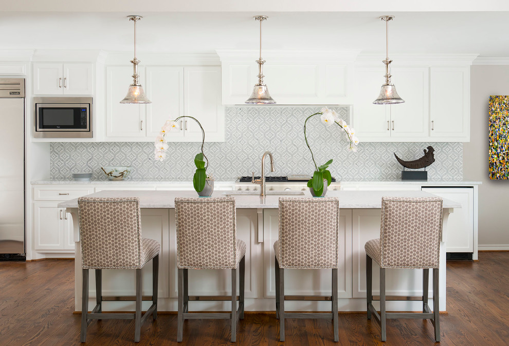 Design ideas for a large transitional single-wall eat-in kitchen in Dallas with flat-panel cabinets, white cabinets, marble benchtops, grey splashback, mosaic tile splashback, stainless steel appliances, medium hardwood floors, with island, an undermount sink and brown floor.
