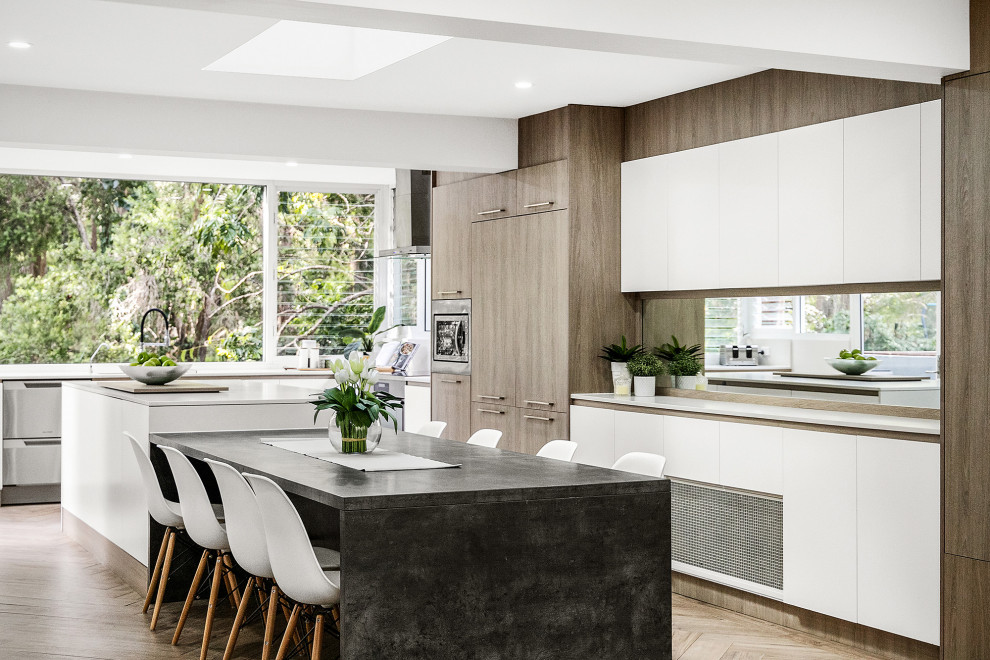 Large l-shaped eat-in kitchen in Sydney with an undermount sink, louvered cabinets, white cabinets, quartz benchtops, white splashback, engineered quartz splashback, stainless steel appliances, ceramic floors, with island, beige floor and white benchtop.