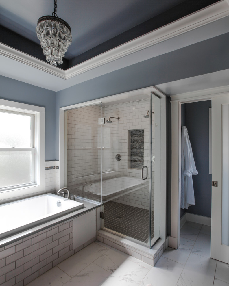 Mid-sized transitional master white tile and subway tile porcelain tile corner shower photo in DC Metro with an undermount sink, recessed-panel cabinets, dark wood cabinets, solid surface countertops, an undermount tub, a two-piece toilet and blue walls