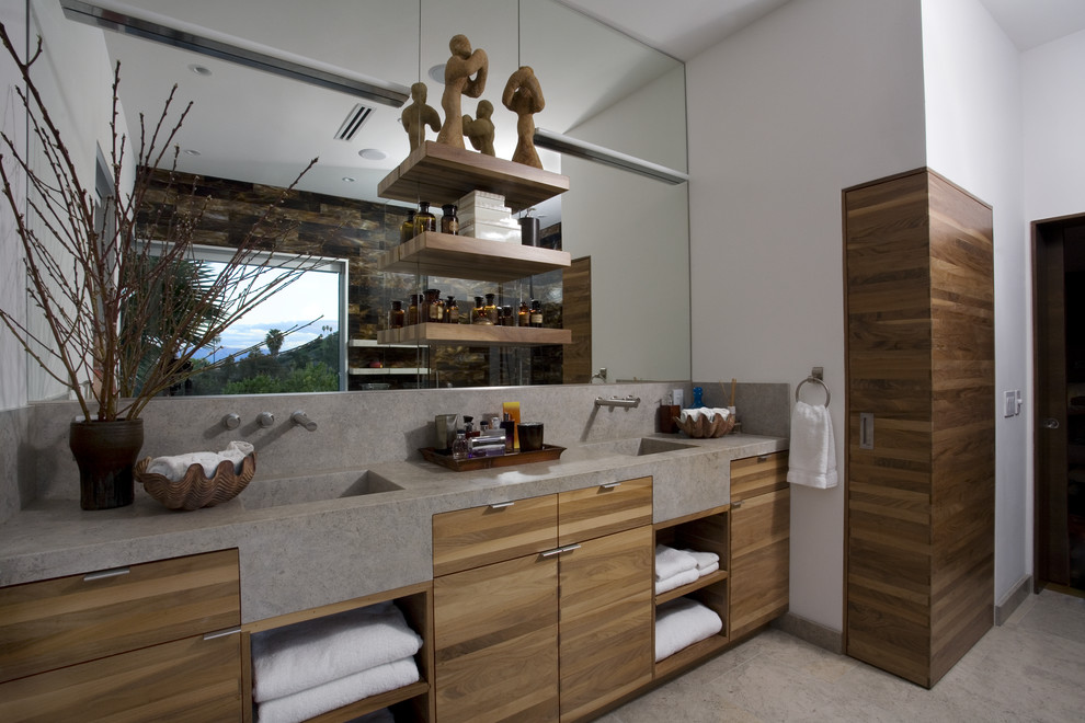 Photo of a mid-sized modern master bathroom in Los Angeles with an integrated sink, furniture-like cabinets, medium wood cabinets, limestone benchtops, gray tile, stone slab and limestone floors.