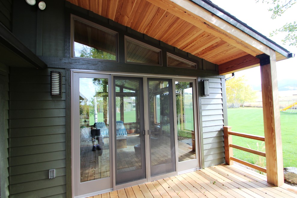 Inspiration for a backyard deck remodel with a roof extension