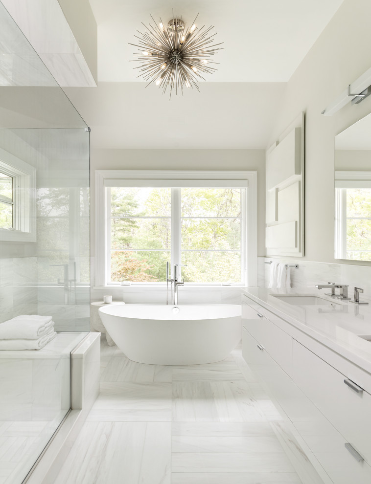 Design ideas for a large transitional master bathroom in New York with flat-panel cabinets, white cabinets, a freestanding tub, a corner shower, white tile, porcelain tile, grey walls, porcelain floors, an undermount sink, white floor, a hinged shower door, white benchtops, a shower seat, a double vanity and a floating vanity.