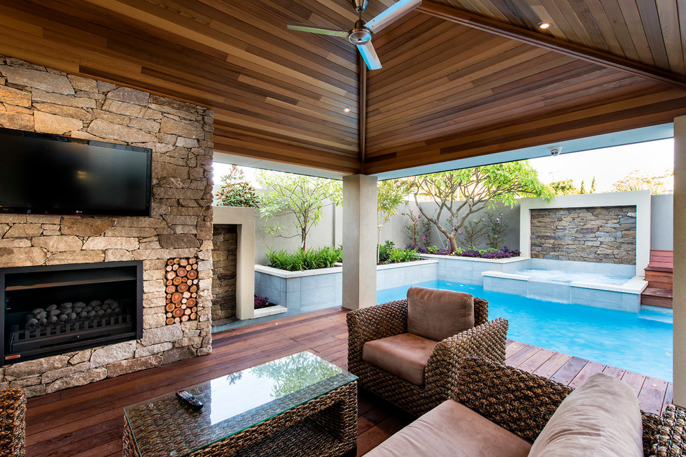 Photo of a large modern backyard rectangular pool in Perth with a water feature.