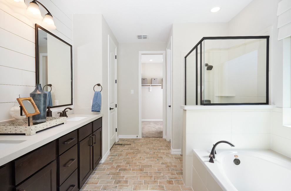 Large contemporary master bathroom in Other with raised-panel cabinets, brown cabinets, a drop-in tub, a corner shower, white tile, ceramic tile, white walls, ceramic floors, an undermount sink, solid surface benchtops, beige floor, a hinged shower door and white benchtops.