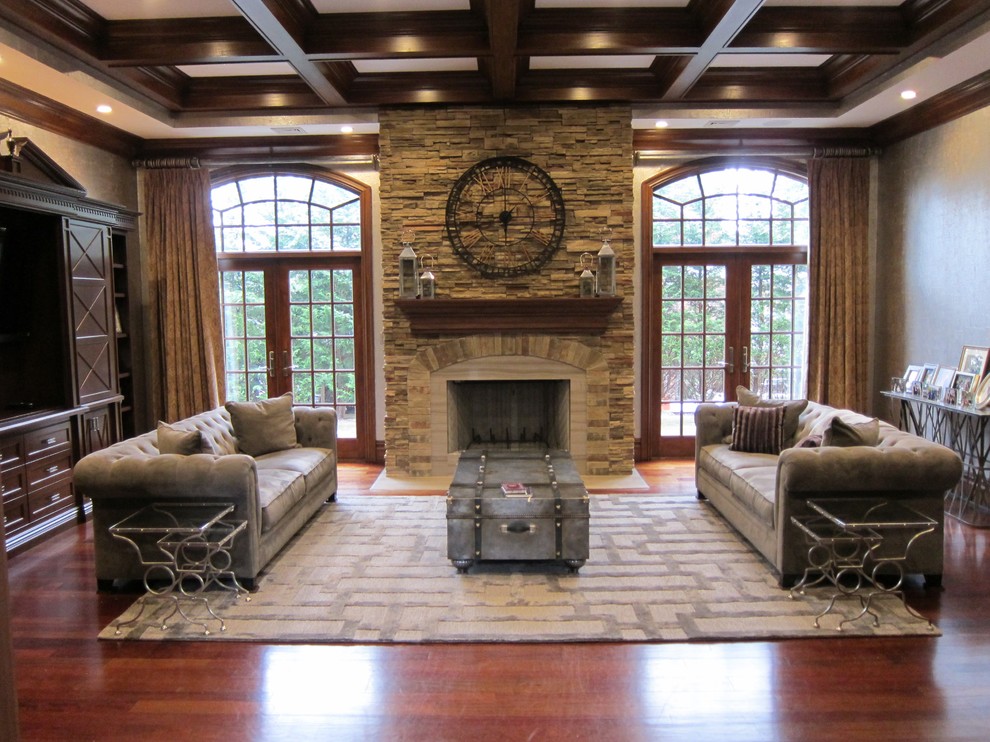 Design ideas for a large industrial enclosed family room in New York with beige walls, dark hardwood floors, a standard fireplace and a stone fireplace surround.