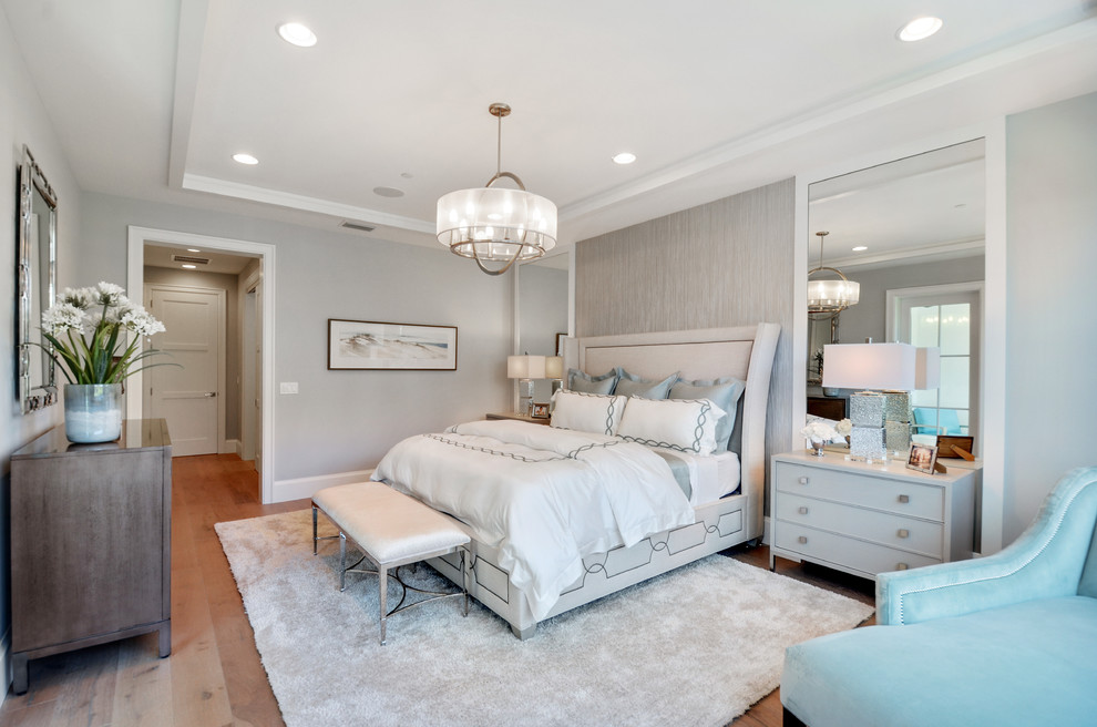 Inspiration for a large transitional master bedroom in Miami with grey walls, medium hardwood floors, no fireplace and brown floor.