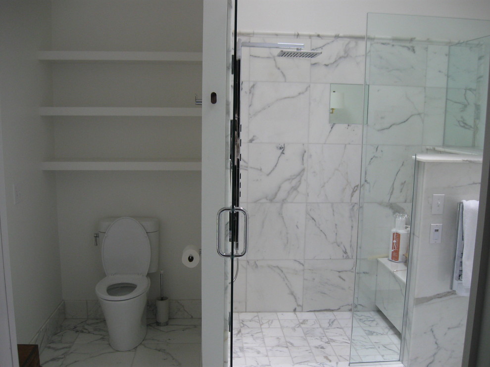 Photo of an expansive traditional master bathroom in St Louis with an undermount sink, shaker cabinets, white cabinets, marble benchtops, a freestanding tub, an alcove shower, a two-piece toilet, white tile, stone tile, white walls, marble floors, white floor and a hinged shower door.